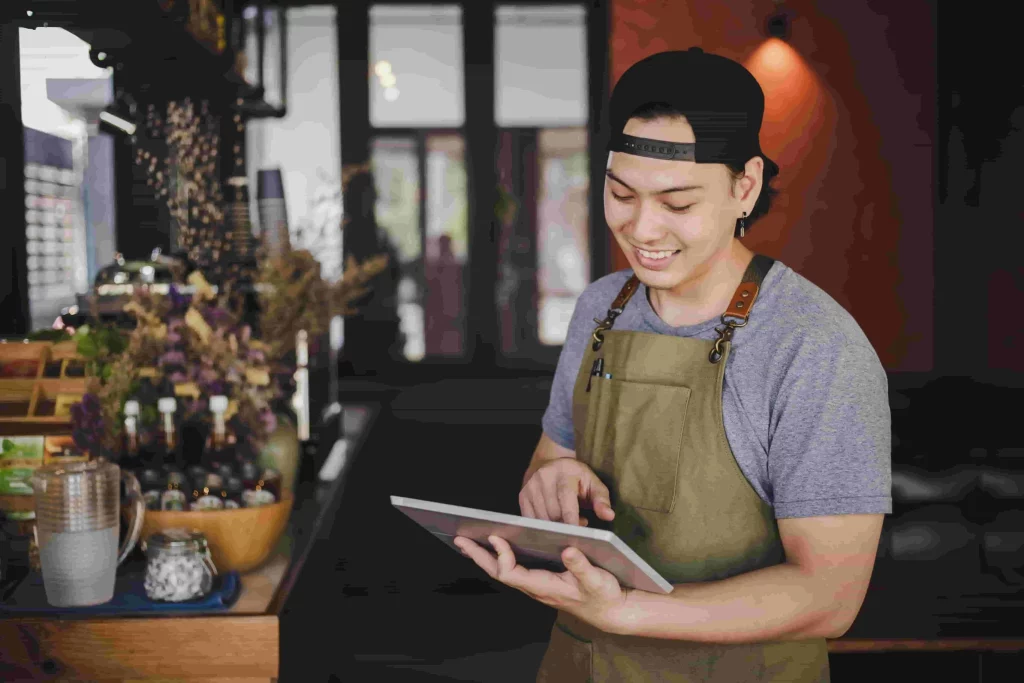 Happy smiling asian barista, girl behind counter, working with POS terminal  and brewing filter kit Stock Photo by benzoix